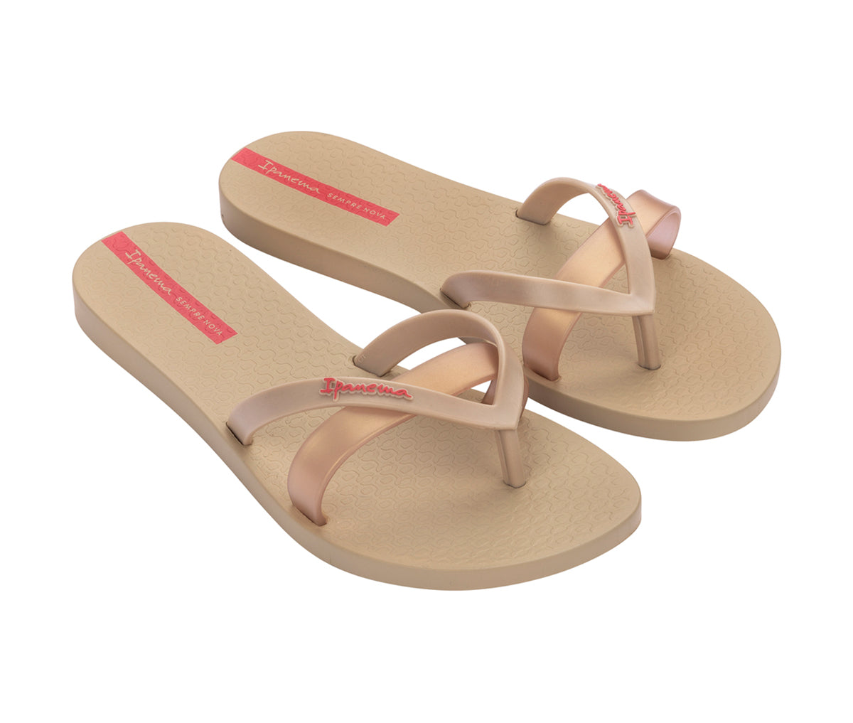 Angled view of a pair of beige with pink gold strap Ipanema Kirei Slides