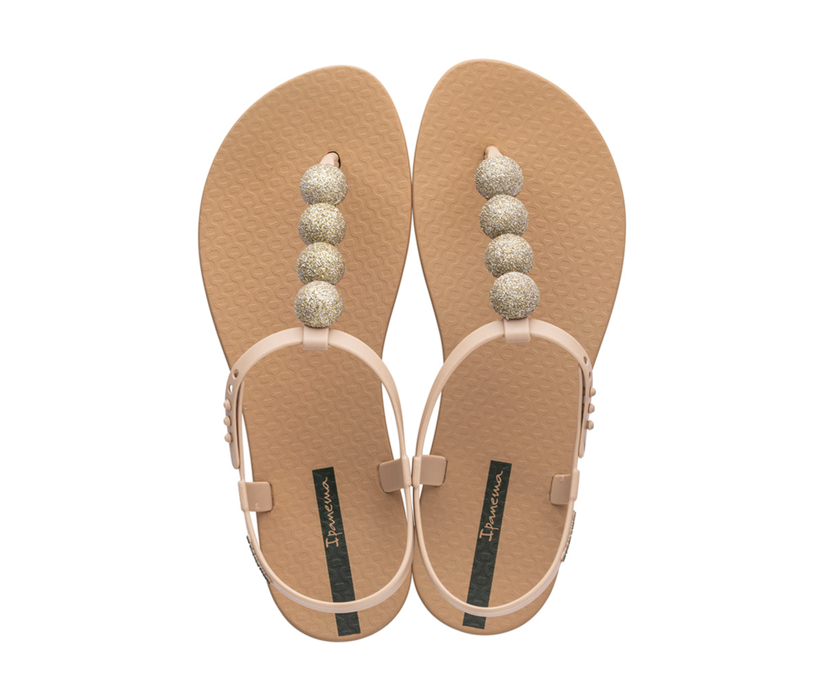 Top view of a pair of beige Ipanema Disco sandals with straps and 4 glitter balls on top strap.