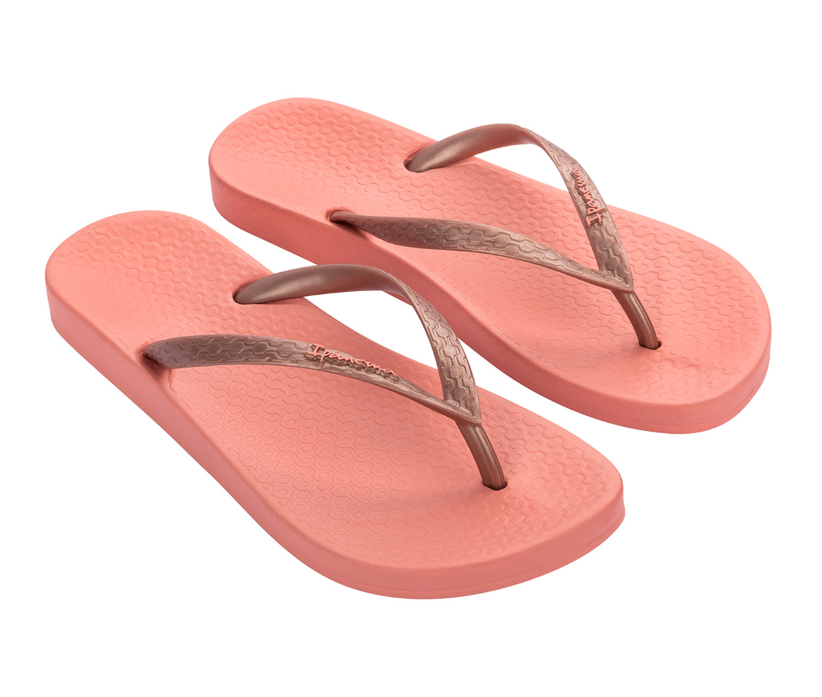 Angled view of a pair of orange Ipanema Ana Tan with rose straps flip flops.
