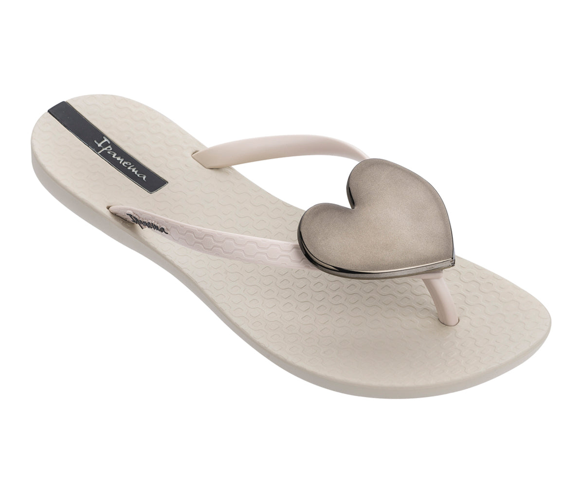 Angled view of a beige Ipanema Wave Heart flip flops with a black heart.