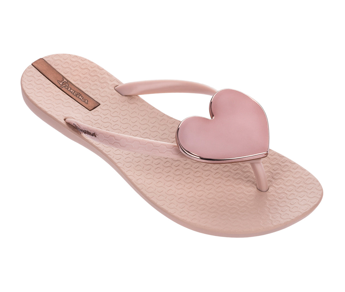Angled view of a pink Ipanema Wave Heart flip flop with a metallic pink heart of top.